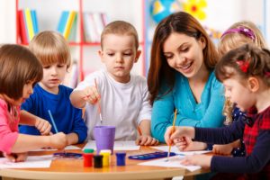 Group Of Elementary Age Children In Art Class With Teacher